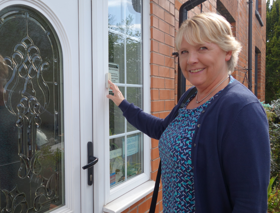 nurse knocking on white front door