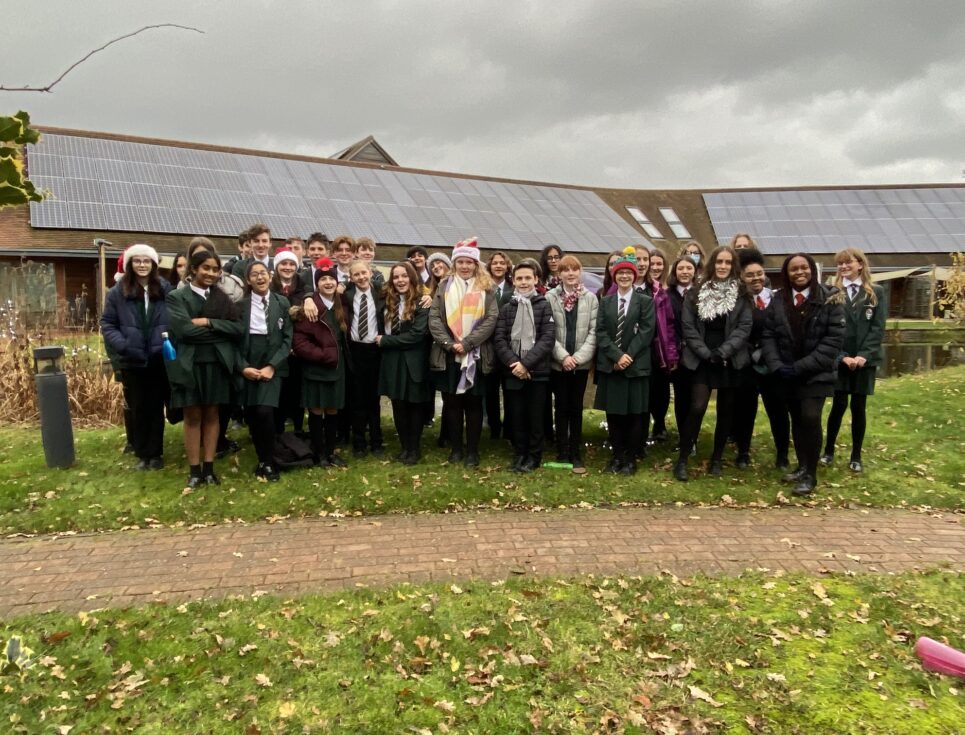 School children gather together in the gardens of St Richard's Hospice to pose for a group picture.